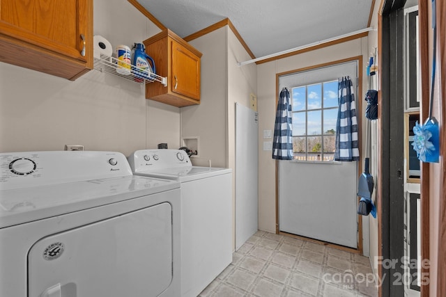 clothes washing area with cabinet space, separate washer and dryer, light floors, and crown molding