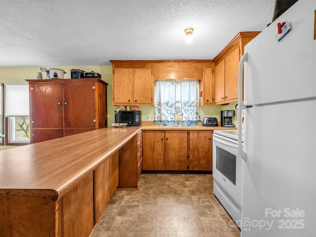 kitchen featuring a sink, white appliances, brown cabinets, and light countertops