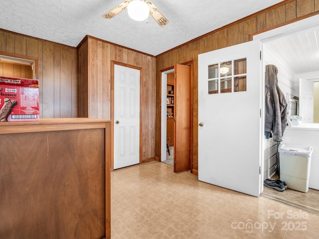 unfurnished bedroom with tile patterned floors, wood walls, and crown molding