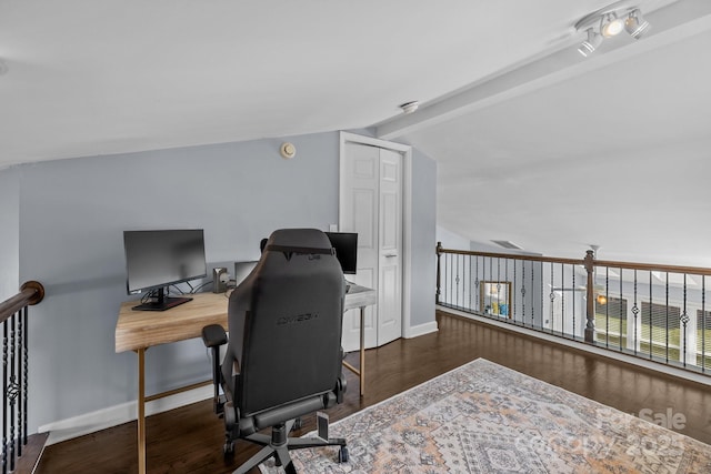 office area featuring lofted ceiling with beams, baseboards, and wood finished floors