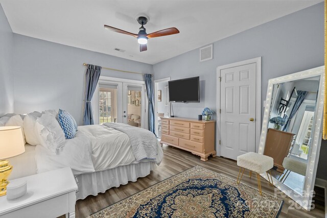 bedroom with visible vents, french doors, wood finished floors, and access to outside