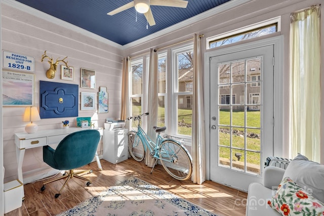 office area with a ceiling fan, crown molding, and wood finished floors