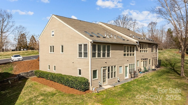 back of house with a lawn