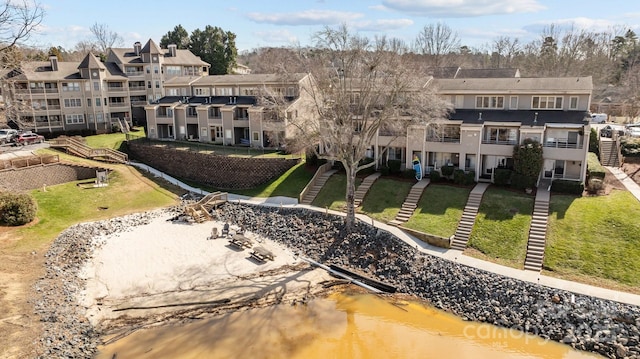 drone / aerial view featuring a residential view and a water view