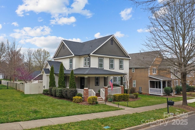 view of front of house with a front lawn, a gate, fence, roof with shingles, and covered porch