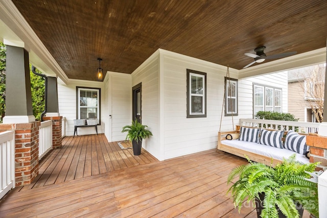 wooden terrace with covered porch and ceiling fan