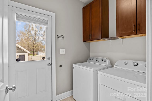 laundry room with cabinet space, baseboards, and washing machine and clothes dryer