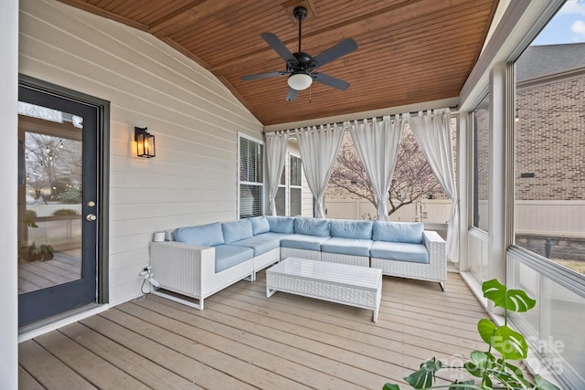 wooden deck featuring an outdoor living space and a ceiling fan