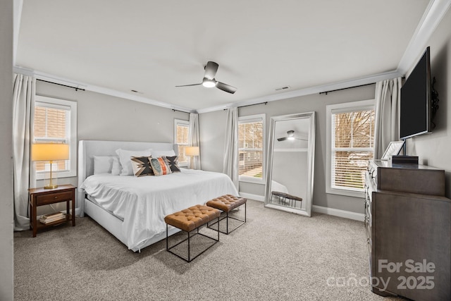 carpeted bedroom with crown molding, baseboards, visible vents, and ceiling fan