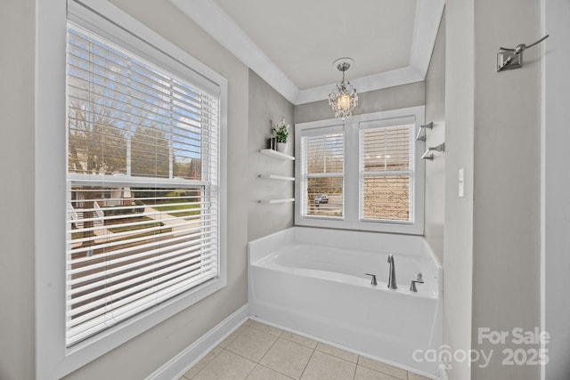 bathroom featuring tile patterned flooring, a bath, baseboards, and a chandelier