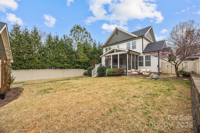 rear view of property with a fenced backyard, roof with shingles, a yard, and a sunroom