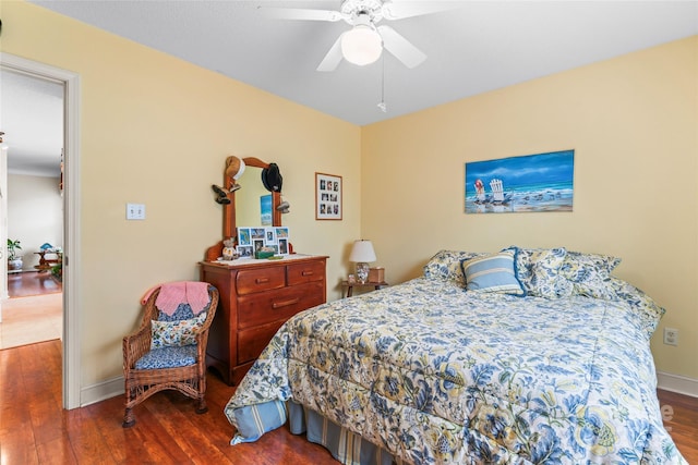 bedroom featuring ceiling fan, baseboards, and wood finished floors