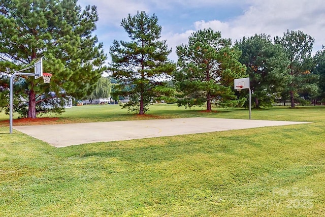 view of basketball court with a lawn and community basketball court