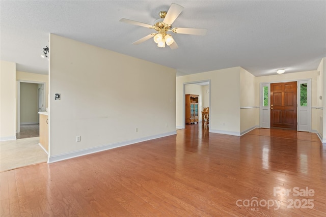 1278 Gracebrook Dr, Salisbury, NC 28147 - unfurnished living room with light wood-style flooring, a ceiling fan, and a textured ceiling
