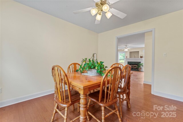 1278 Gracebrook Dr, Salisbury, NC 28147 - dining space with ceiling fan, wood finished floors, and a fireplace