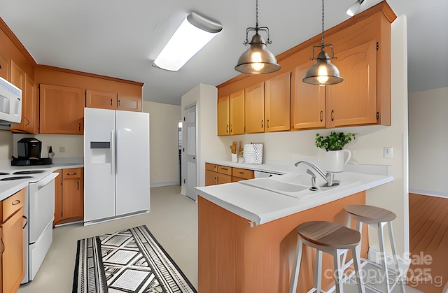 1278 Gracebrook Dr, Salisbury, NC 28147 - kitchen featuring white appliances, a peninsula, light countertops, and a breakfast bar area