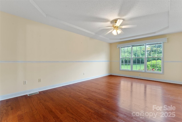 1278 Gracebrook Dr, Salisbury, NC 28147 - unfurnished room featuring a raised ceiling, a ceiling fan, wood finished floors, and a textured ceiling