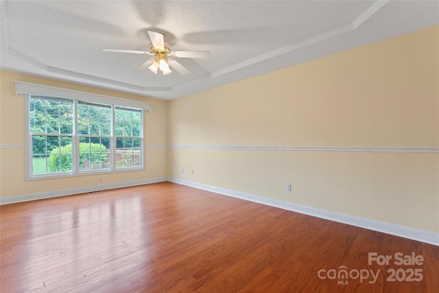 1278 Gracebrook Dr, Salisbury, NC 28147 - unfurnished room featuring a raised ceiling, a ceiling fan, wood finished floors, and a textured ceiling