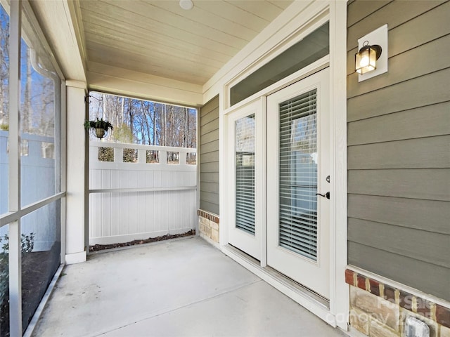 unfurnished sunroom featuring wooden ceiling