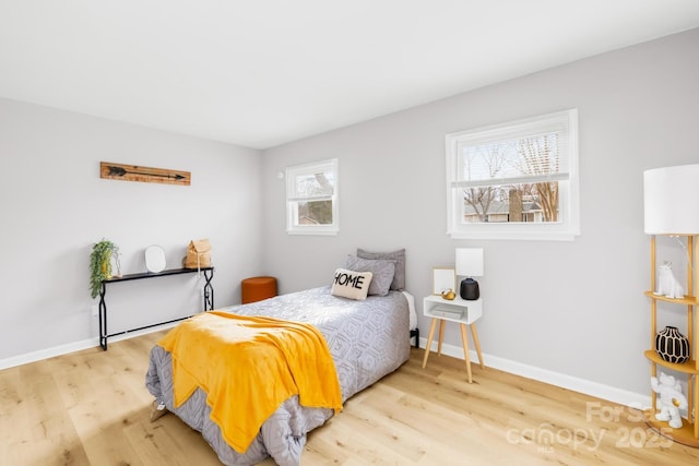 bedroom featuring baseboards and wood finished floors