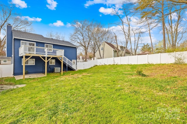 view of yard featuring a wooden deck, stairs, central AC unit, a fenced backyard, and a patio