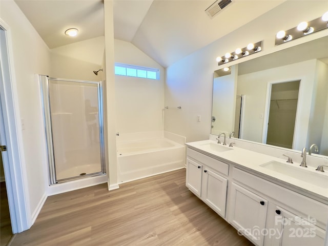 full bathroom with a sink, visible vents, lofted ceiling, and a stall shower