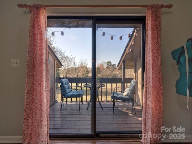 doorway to outside featuring a healthy amount of sunlight and hardwood / wood-style flooring