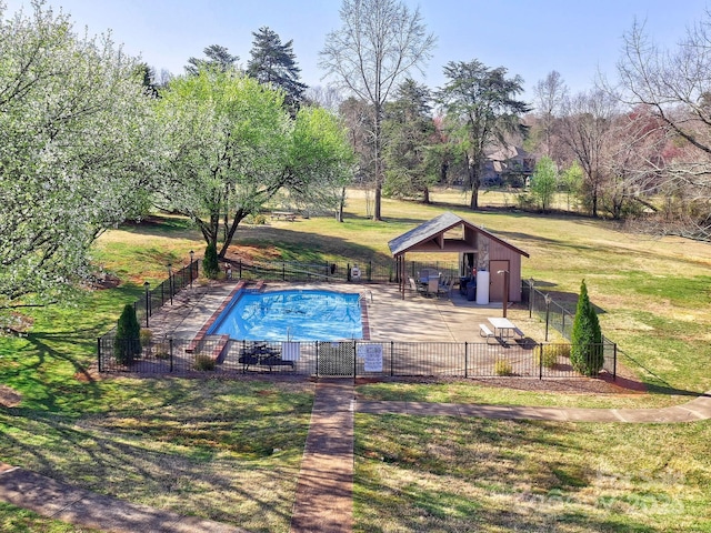 community pool featuring a patio, fence, a lawn, and an outdoor structure