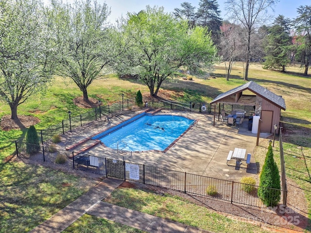 community pool featuring a gazebo, a yard, a patio, and fence