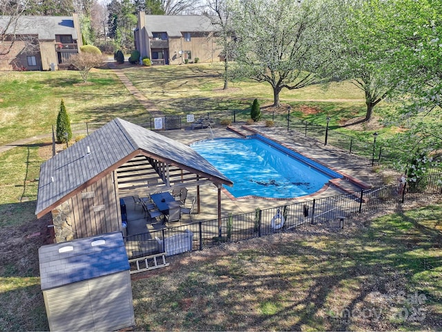 community pool with a patio and fence