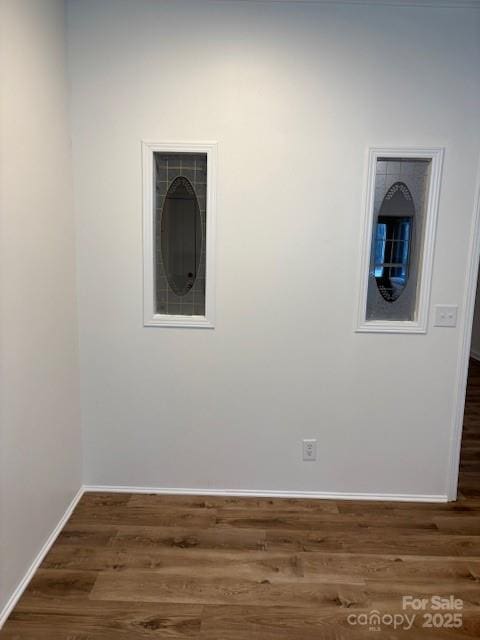 unfurnished room featuring dark wood finished floors and baseboards