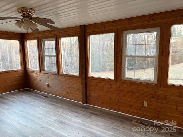 unfurnished sunroom featuring visible vents and ceiling fan