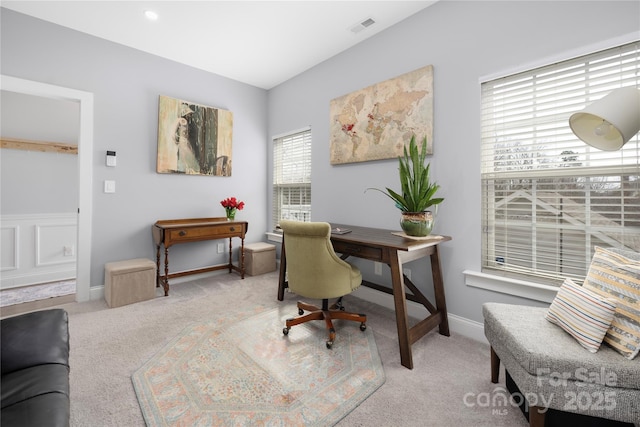 carpeted home office featuring visible vents and baseboards