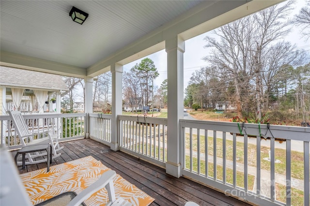 wooden deck featuring a residential view and a porch