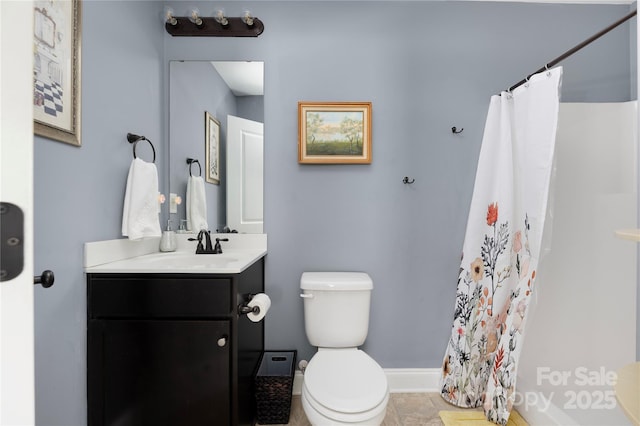 bathroom featuring vanity, toilet, a shower with shower curtain, and baseboards