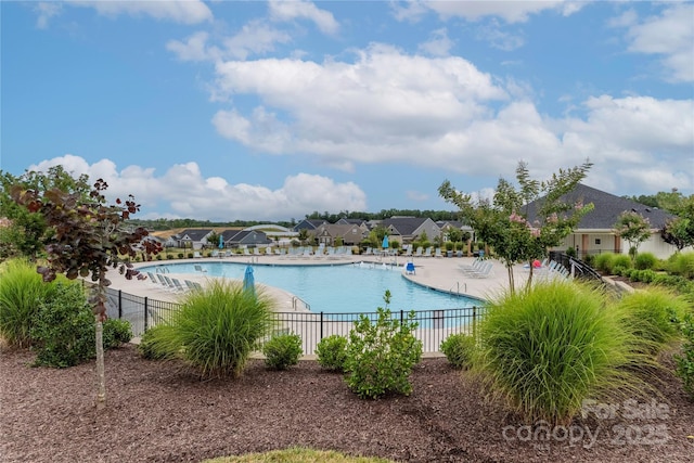 pool featuring a patio area and fence