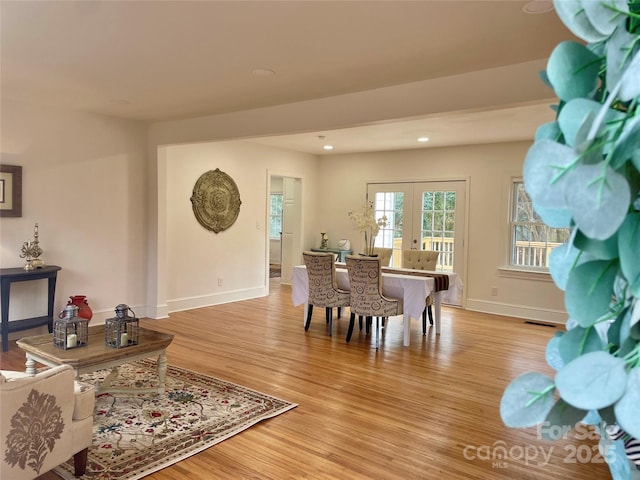 dining area featuring visible vents, baseboards, light wood-type flooring, recessed lighting, and french doors