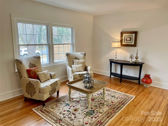 living area featuring wood finished floors and baseboards