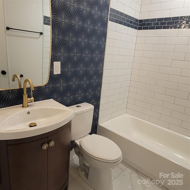 full bathroom featuring vanity, toilet, marble finish floor, and shower / washtub combination