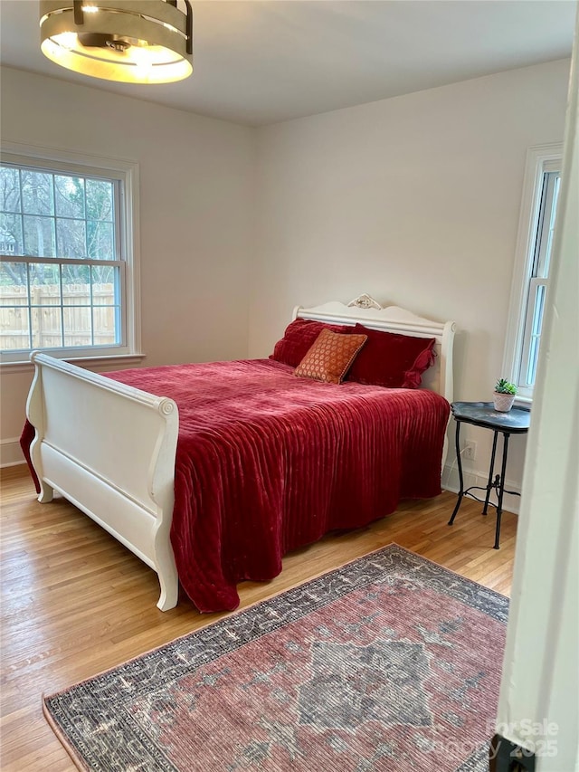 bedroom with baseboards and wood finished floors
