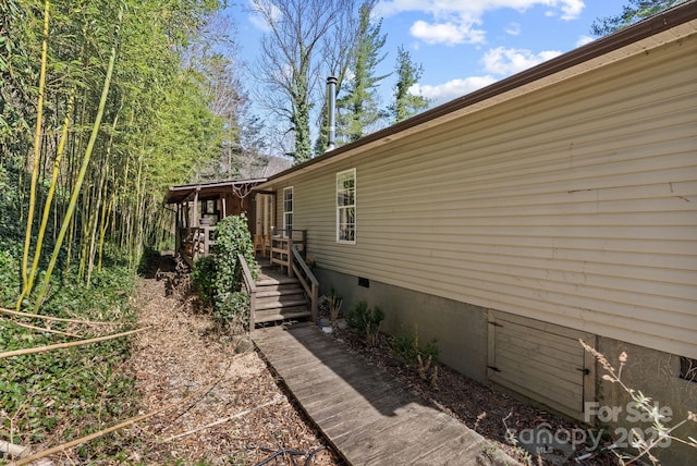 view of side of home featuring crawl space