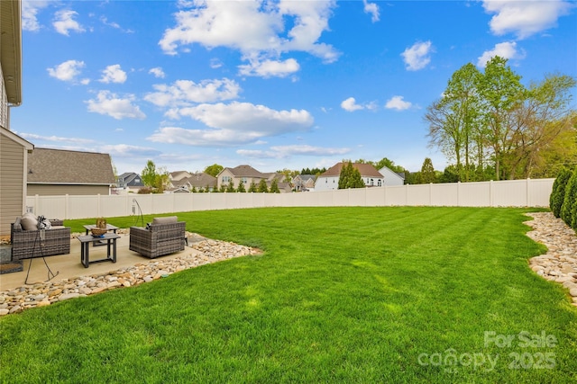 view of yard with a patio area, a residential view, a fenced backyard, and outdoor lounge area
