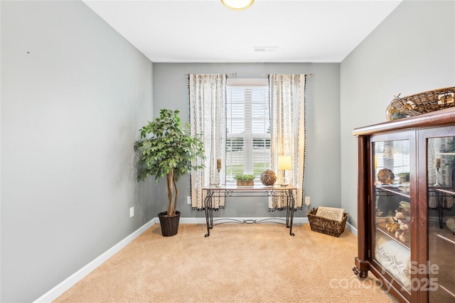 living area featuring visible vents, baseboards, and carpet flooring