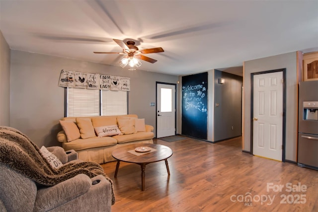 living area with ceiling fan and wood finished floors