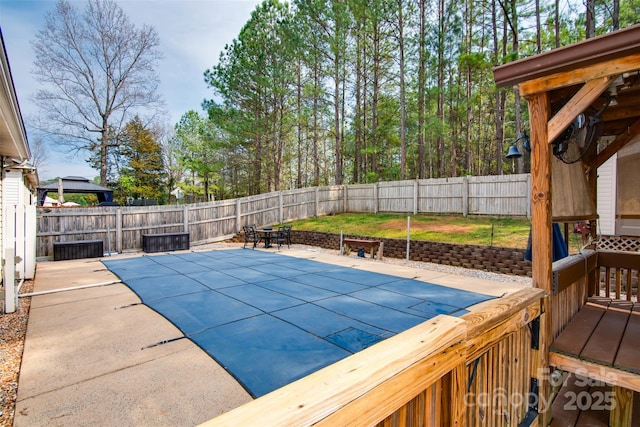 view of swimming pool featuring a patio and a fenced backyard