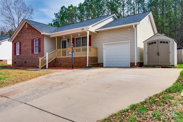 ranch-style home featuring a garage, driveway, a porch, a shed, and crawl space