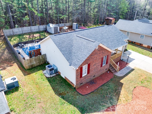 drone / aerial view featuring a wooded view