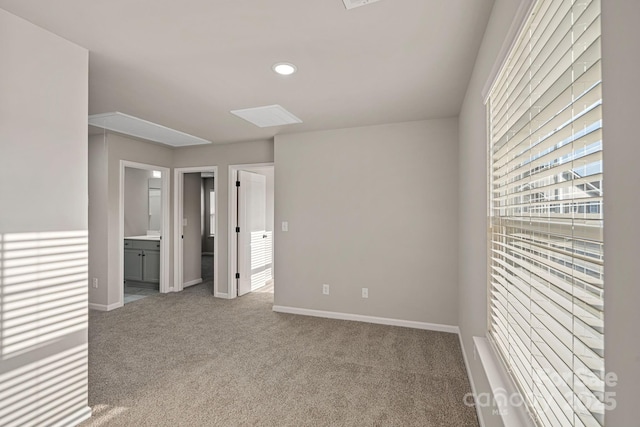 carpeted empty room featuring recessed lighting and baseboards