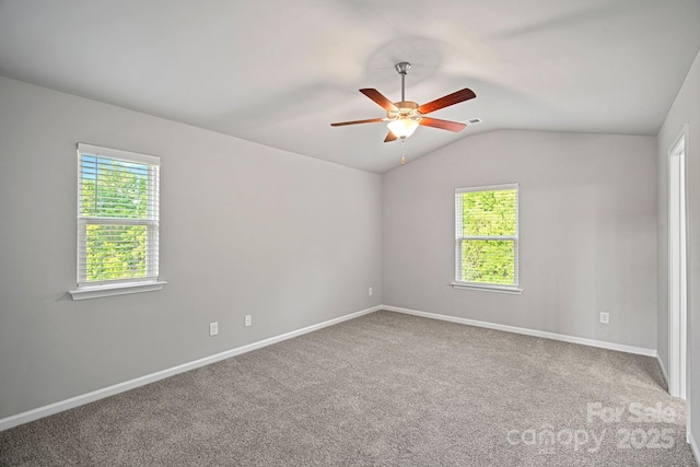 spare room featuring visible vents, baseboards, carpet, ceiling fan, and lofted ceiling