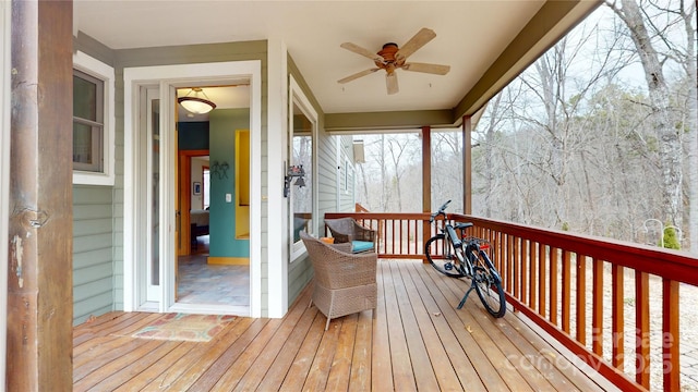 wooden deck with a ceiling fan